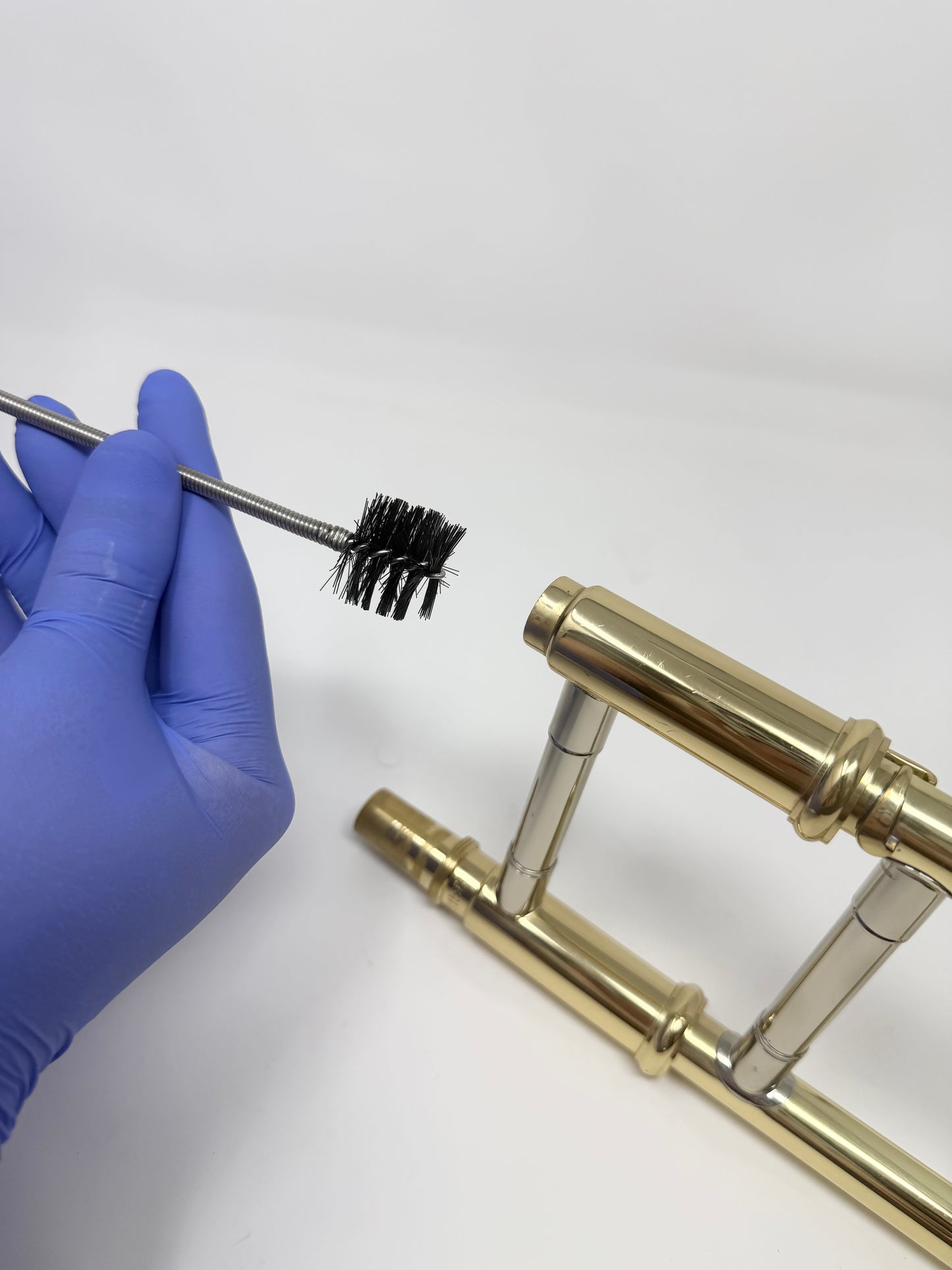 Snake brush for cleaning a trombone mouthpiece