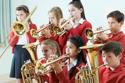 Group of young children playing band instruments