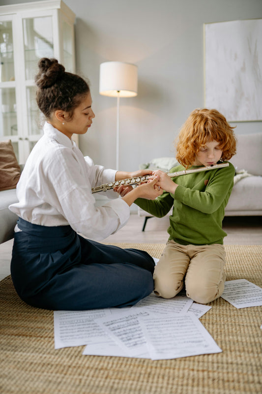 Boy learning flute with teacher