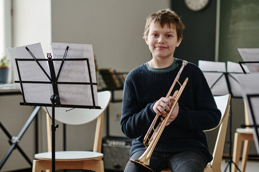 boy sitting with a trumpet