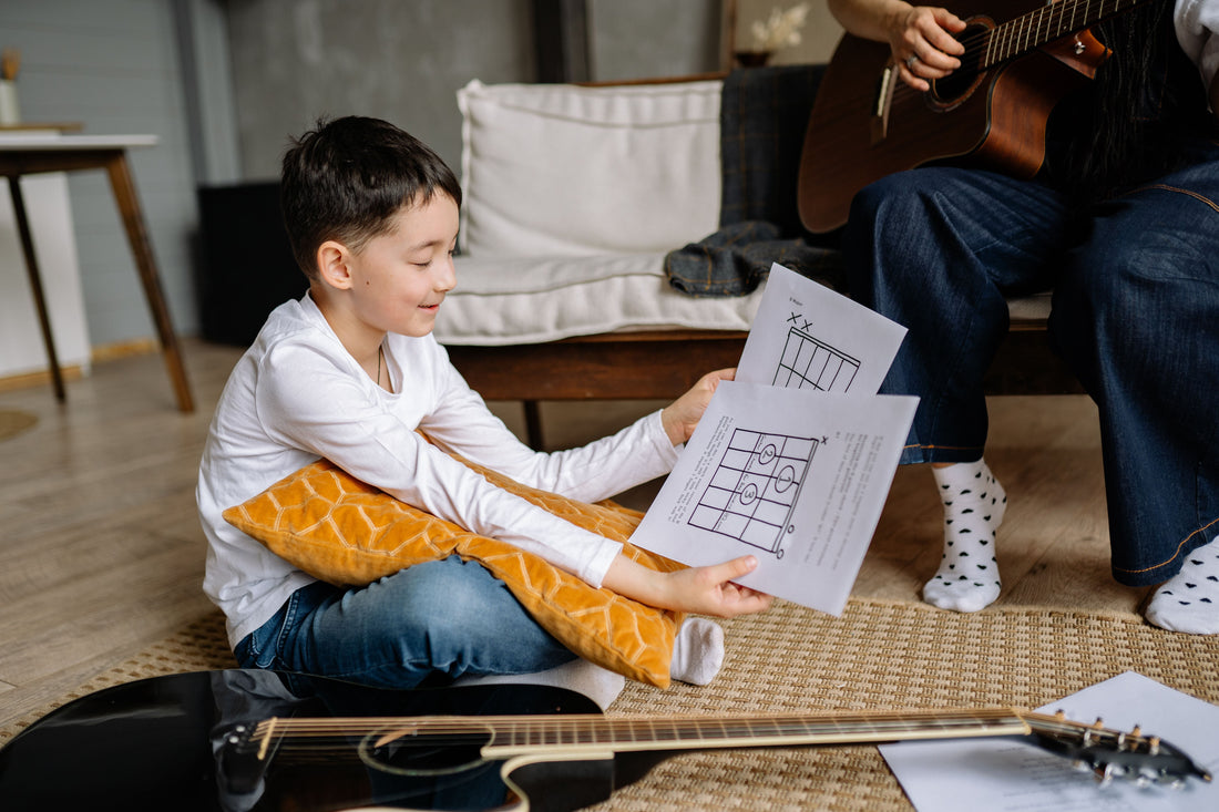 Boy on floor with guitar