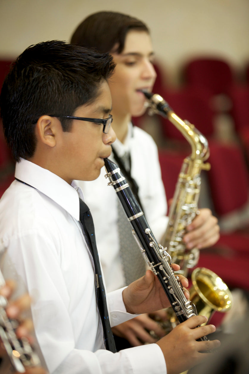 Boy playing clarinet and another student playing saxophone