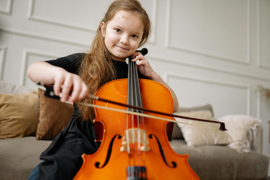Girl smiling while playing cello