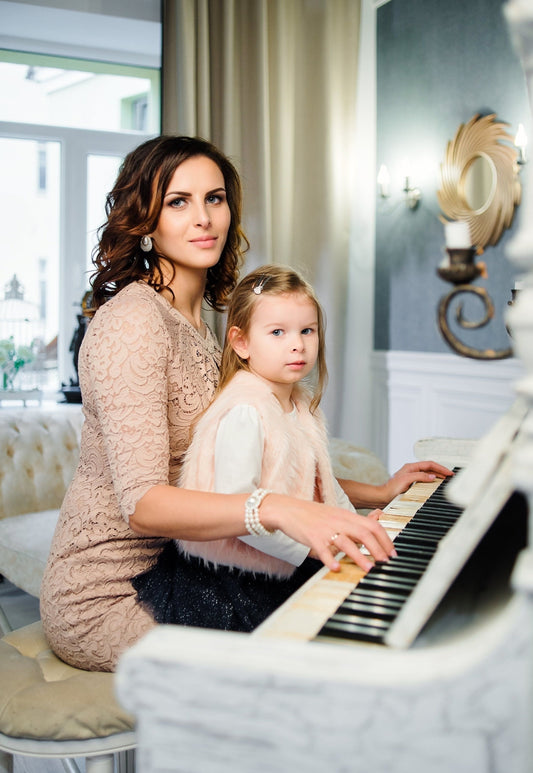 Mom with young child at piano