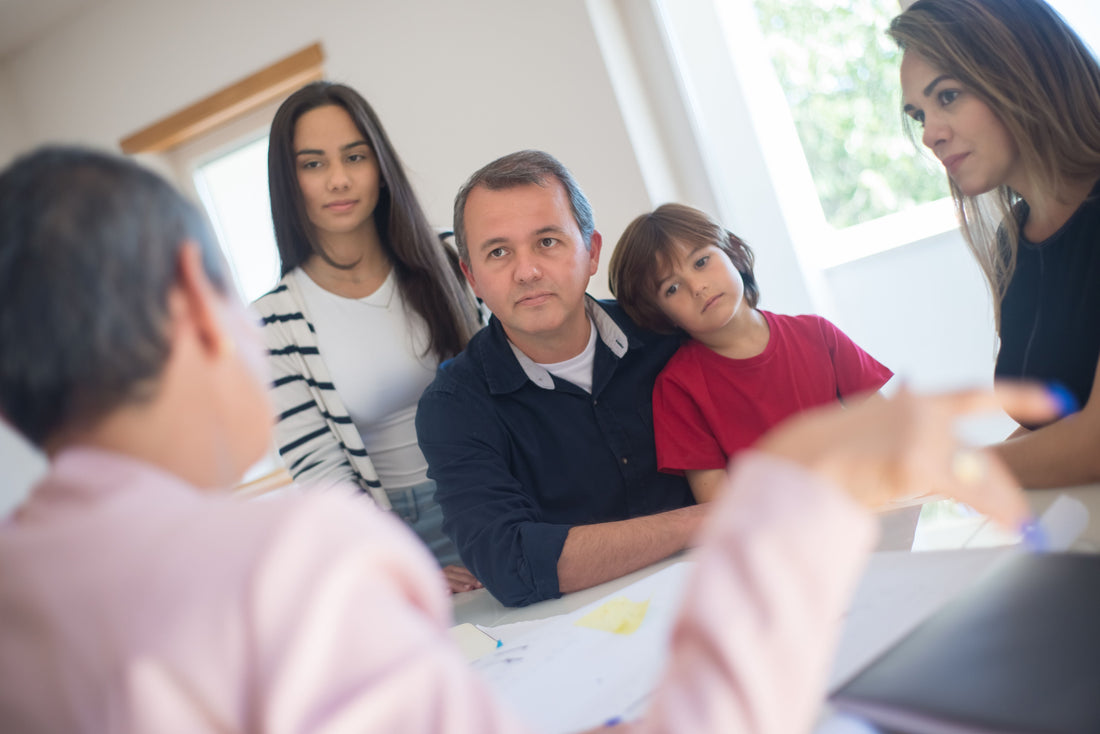Parents with teachers and child