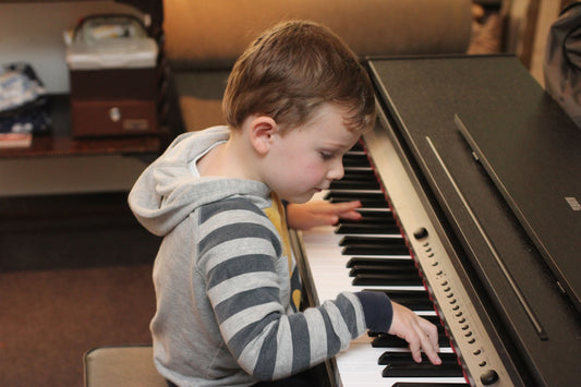 Boy playing an electric keyboard