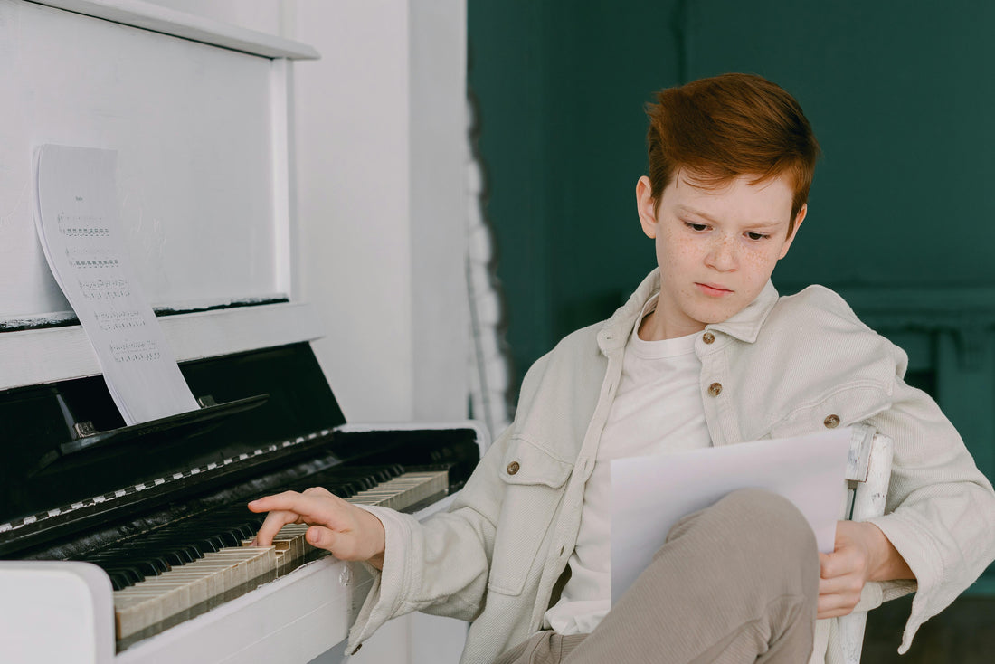 piano boy at piano with sheet music