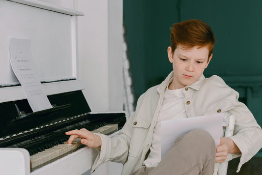 piano boy at piano with sheet music