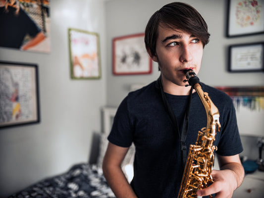 Teen boy playing saxophone