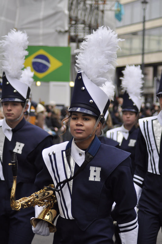 Boy holding saxophone in marching band