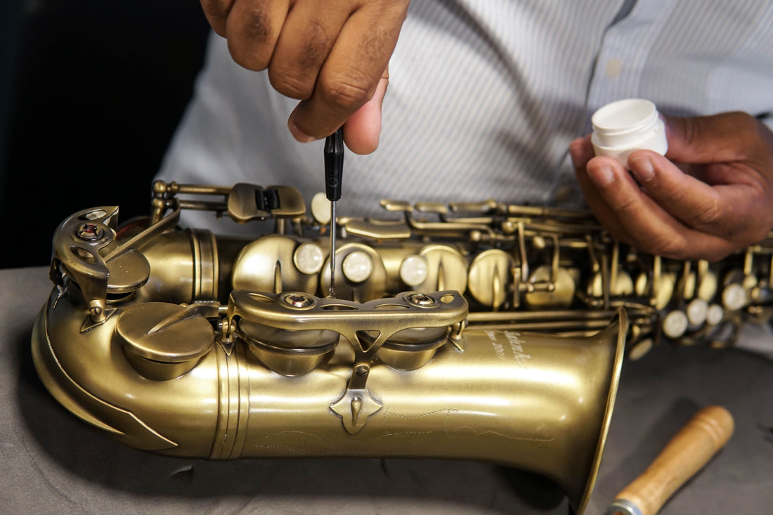 Saxophone being adjusted by a repair technician