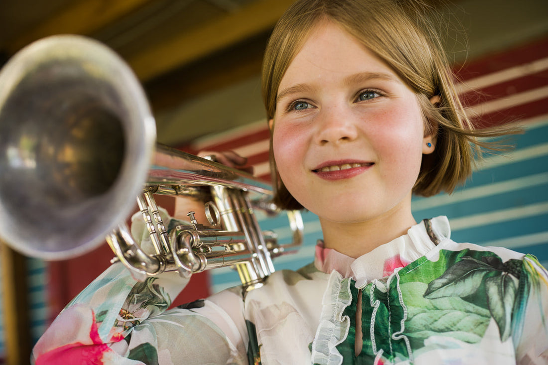 Girl Smiling with a trumpet