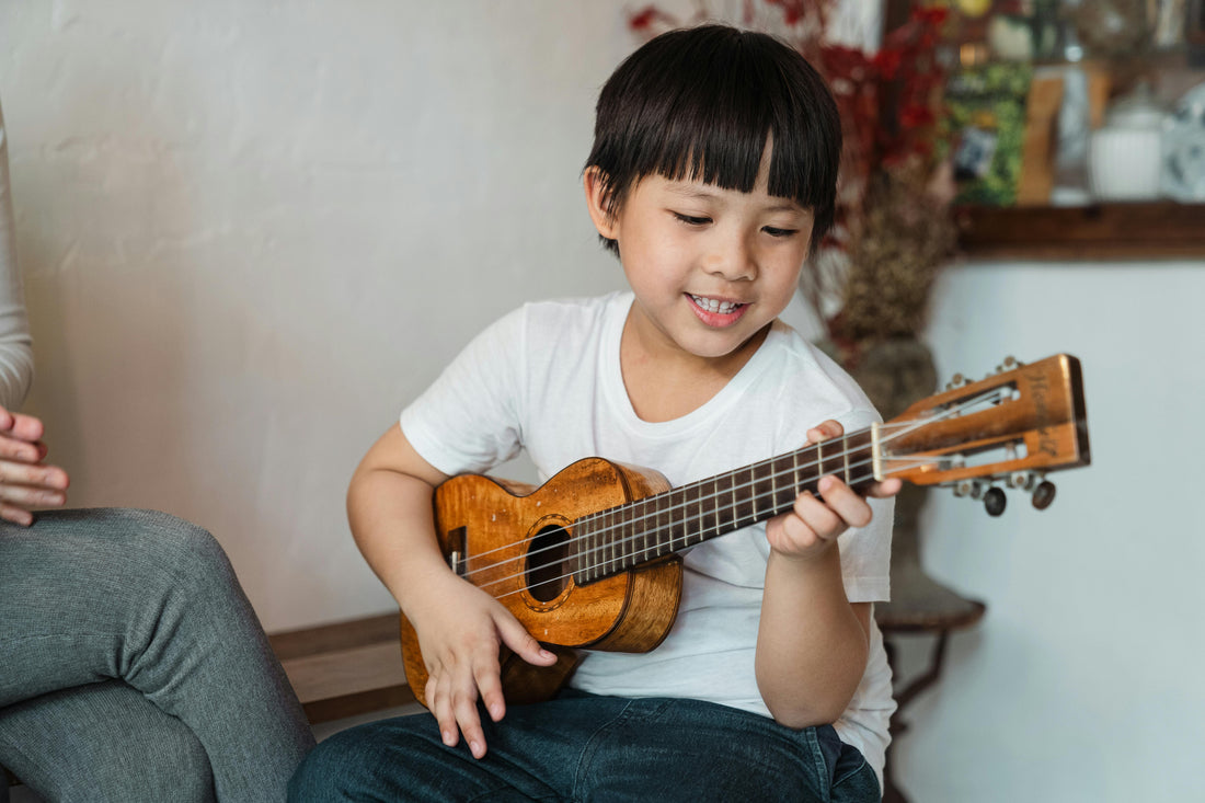 Boy playing a ukulele