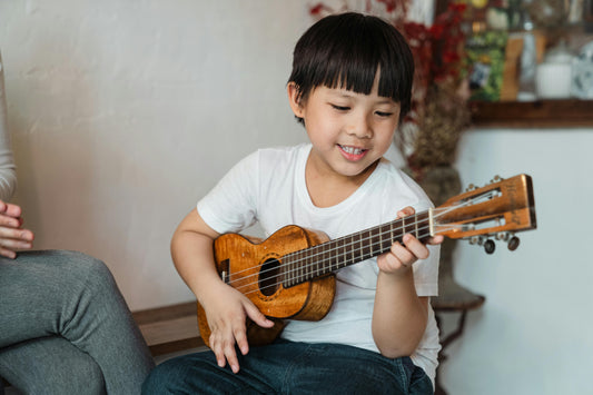Boy playing a ukulele