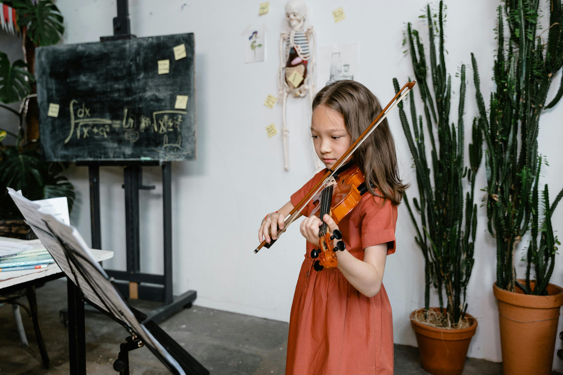 Violin girl playing instrument in front of math board