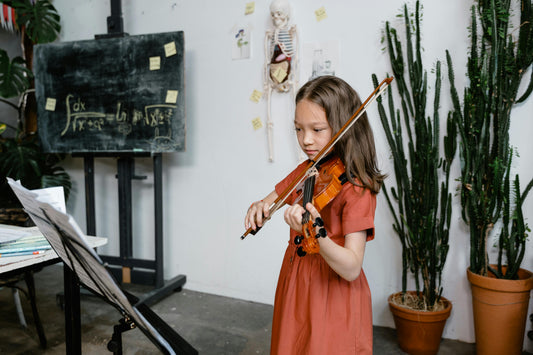 Violin girl playing instrument in front of math board