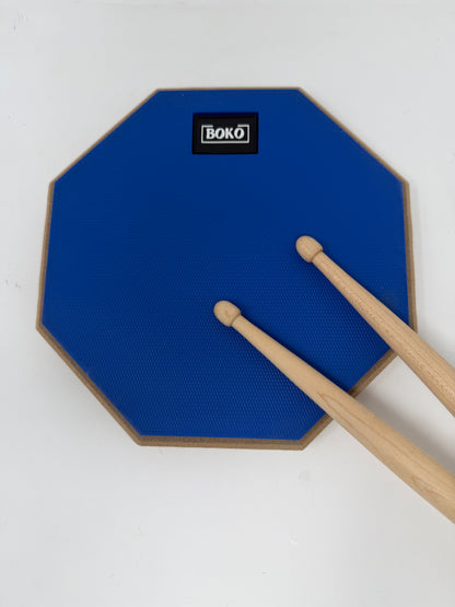 BOKO drum practice pad shown with drumsticks