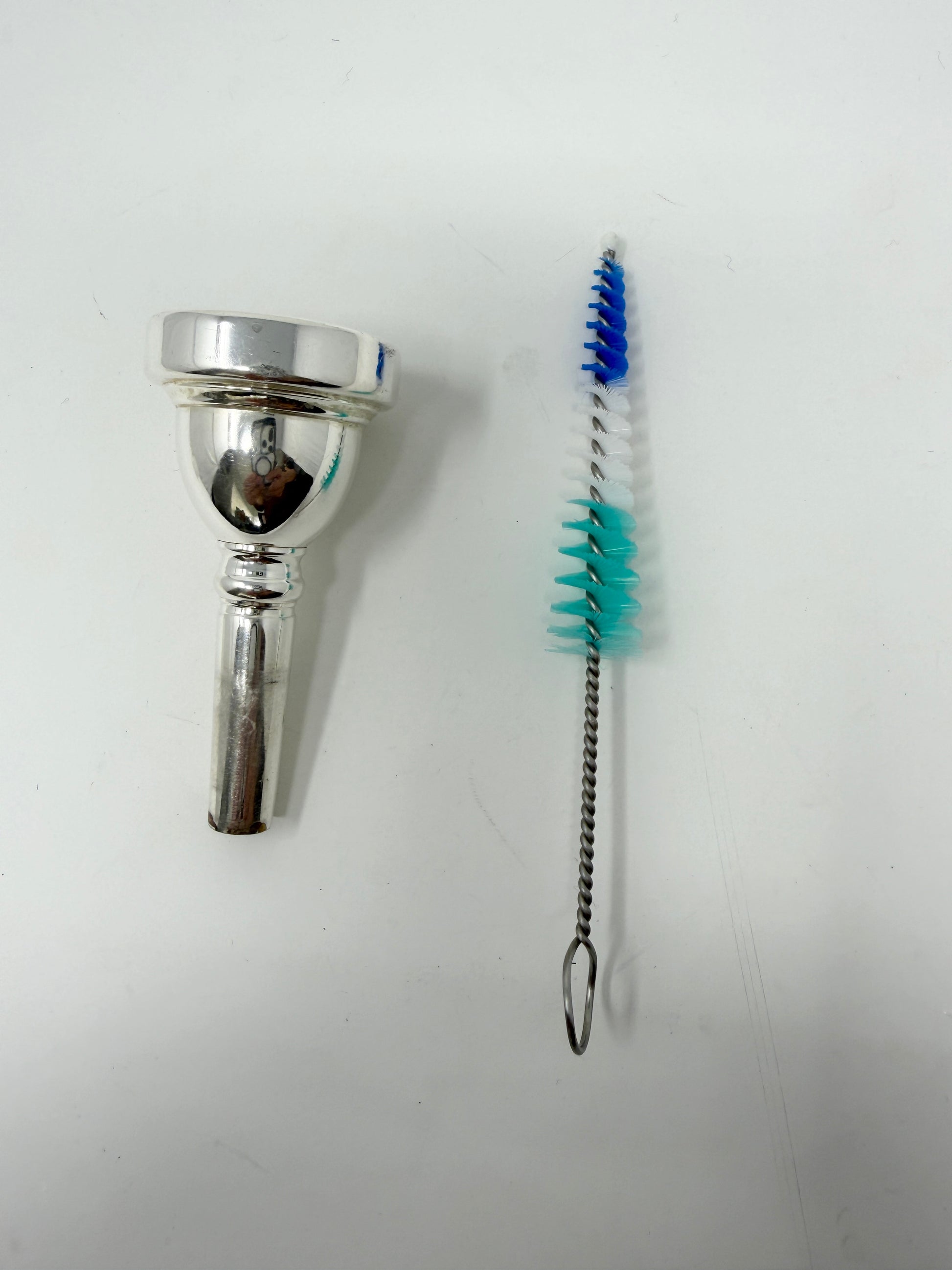 Conical brush for cleaning a trombone mouthpiece