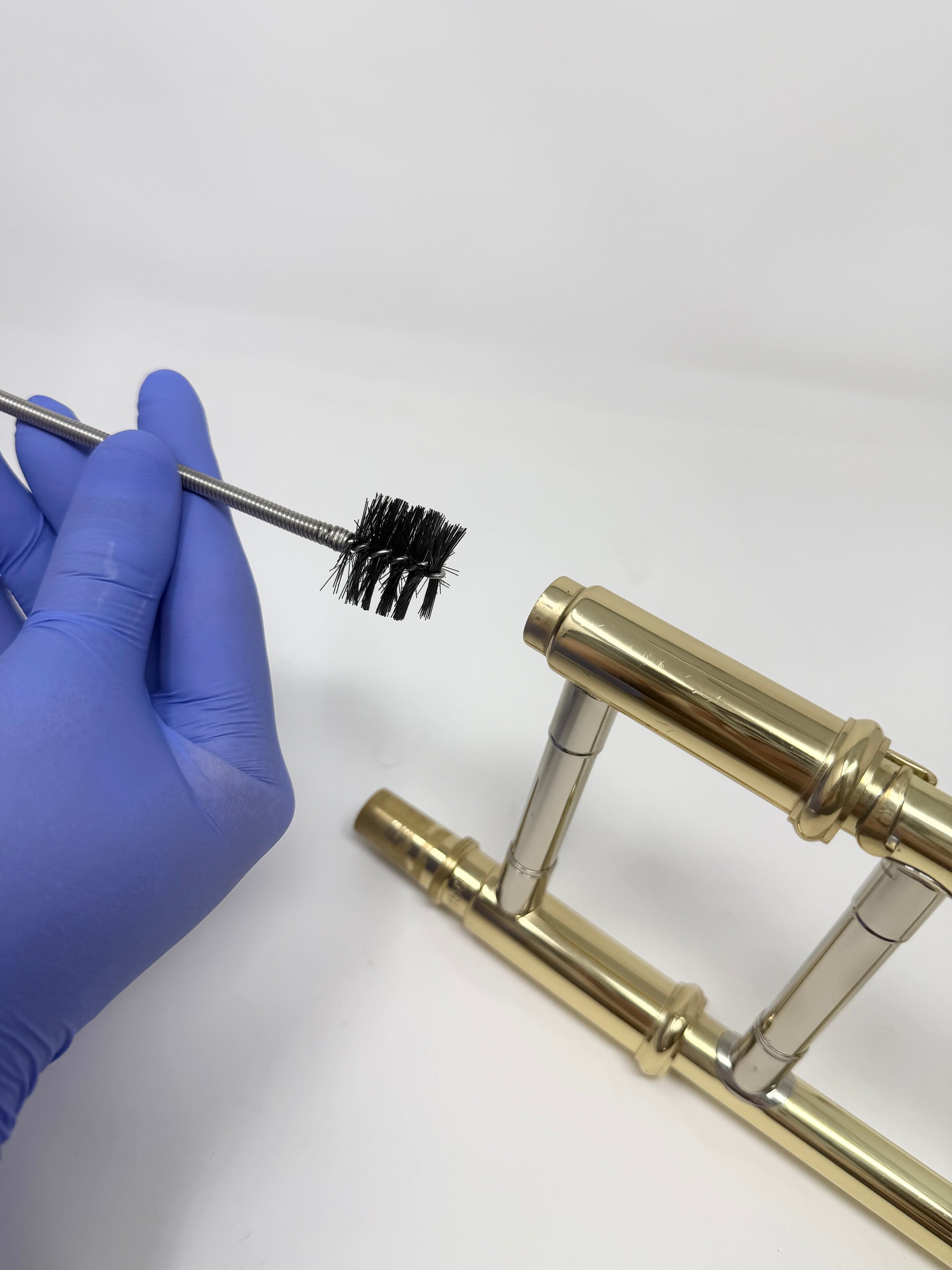 Snake brush for cleaning a trombone mouthpiece
