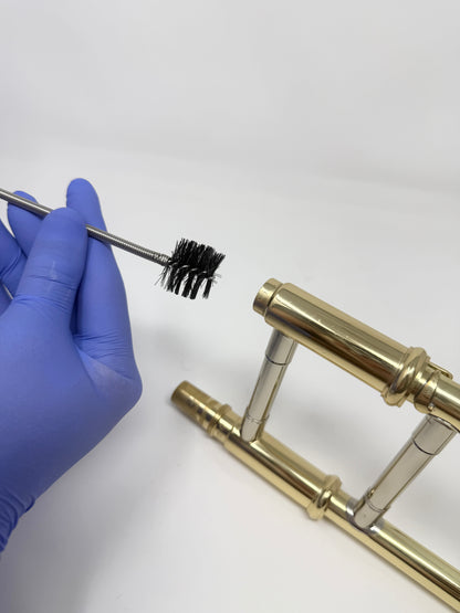 Snake brush for cleaning a trombone mouthpiece