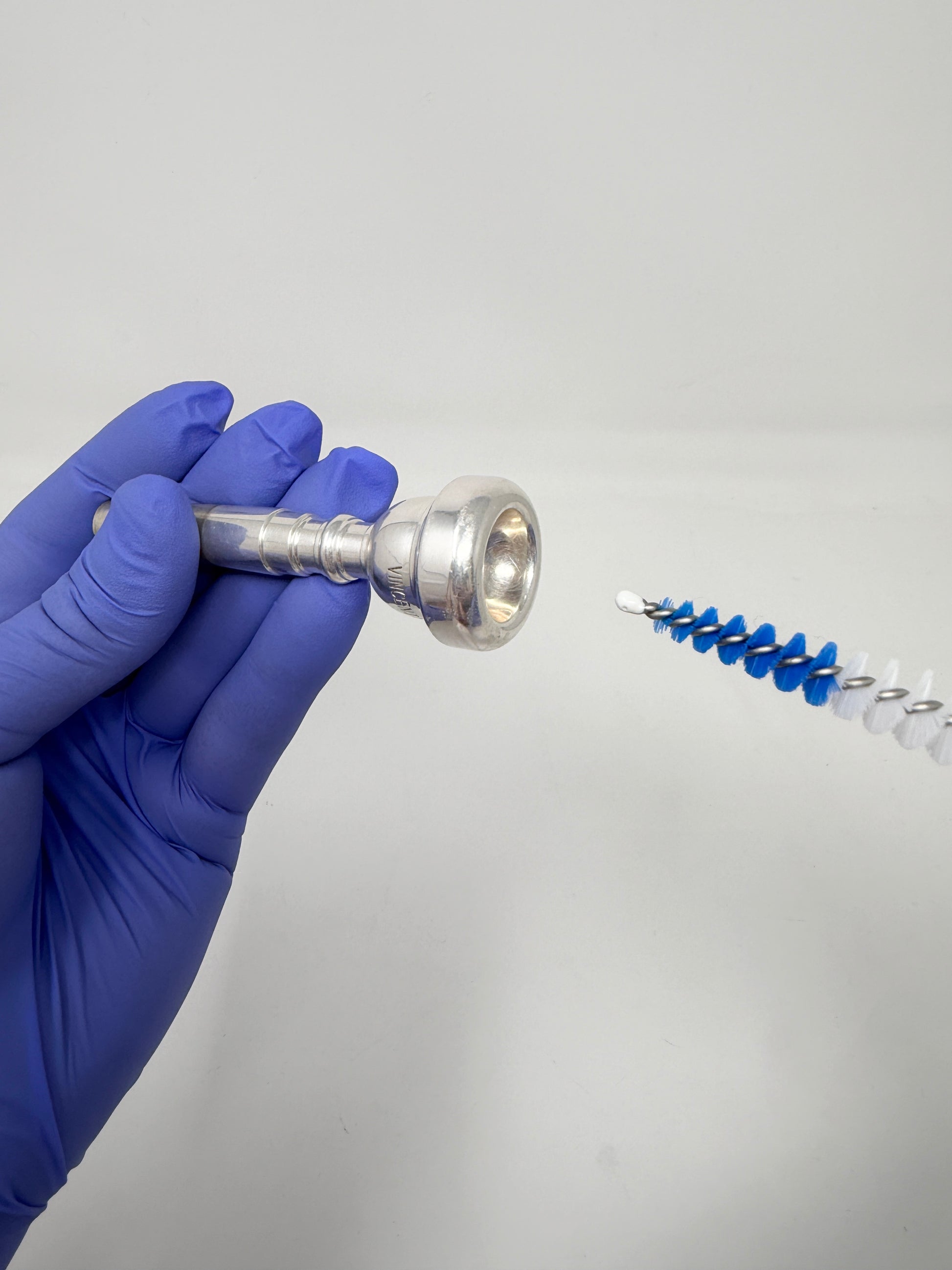 Conical brush for cleaning a trumpet mouthpiece