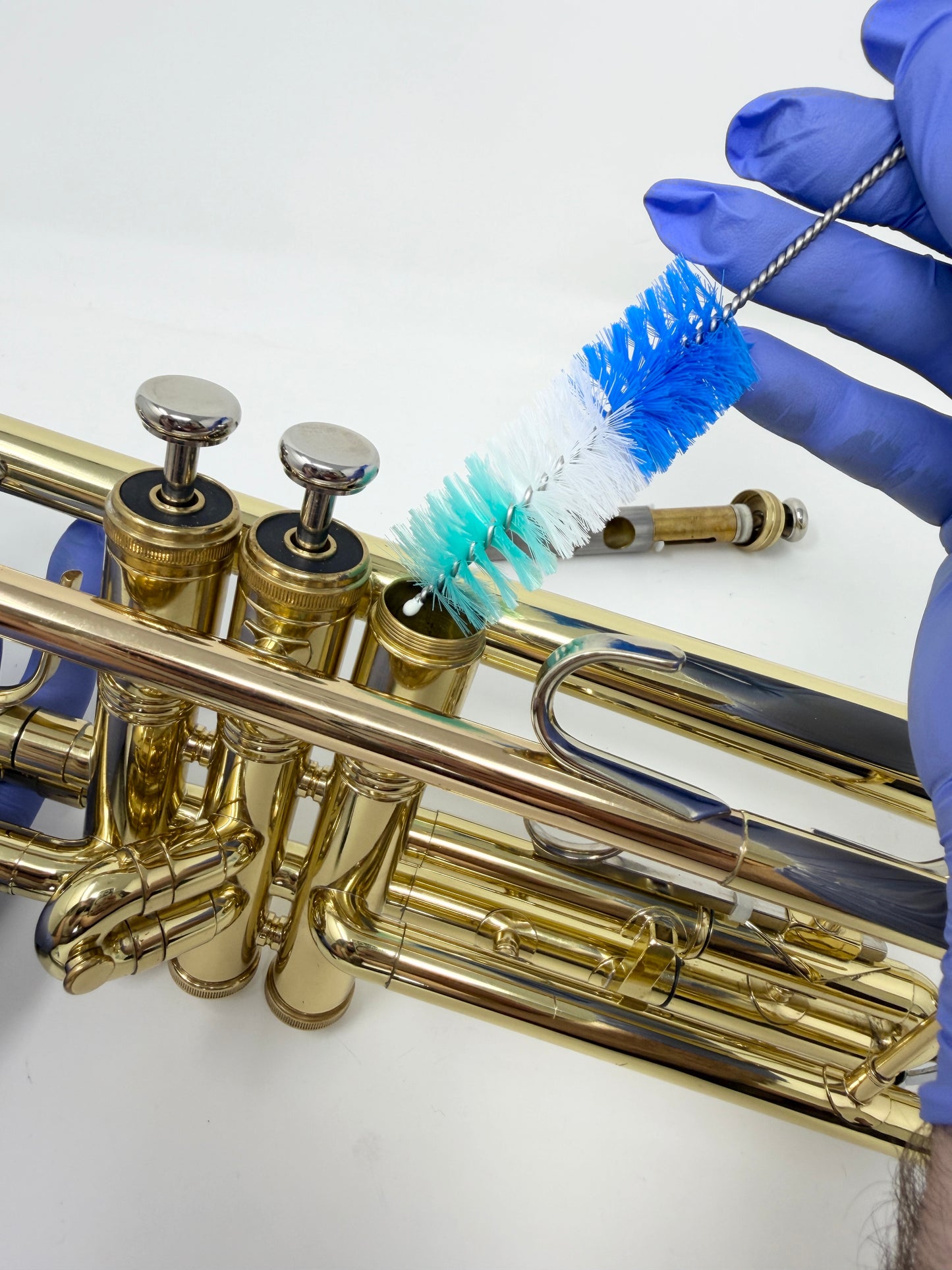 Round brush for cleaning a trumpet