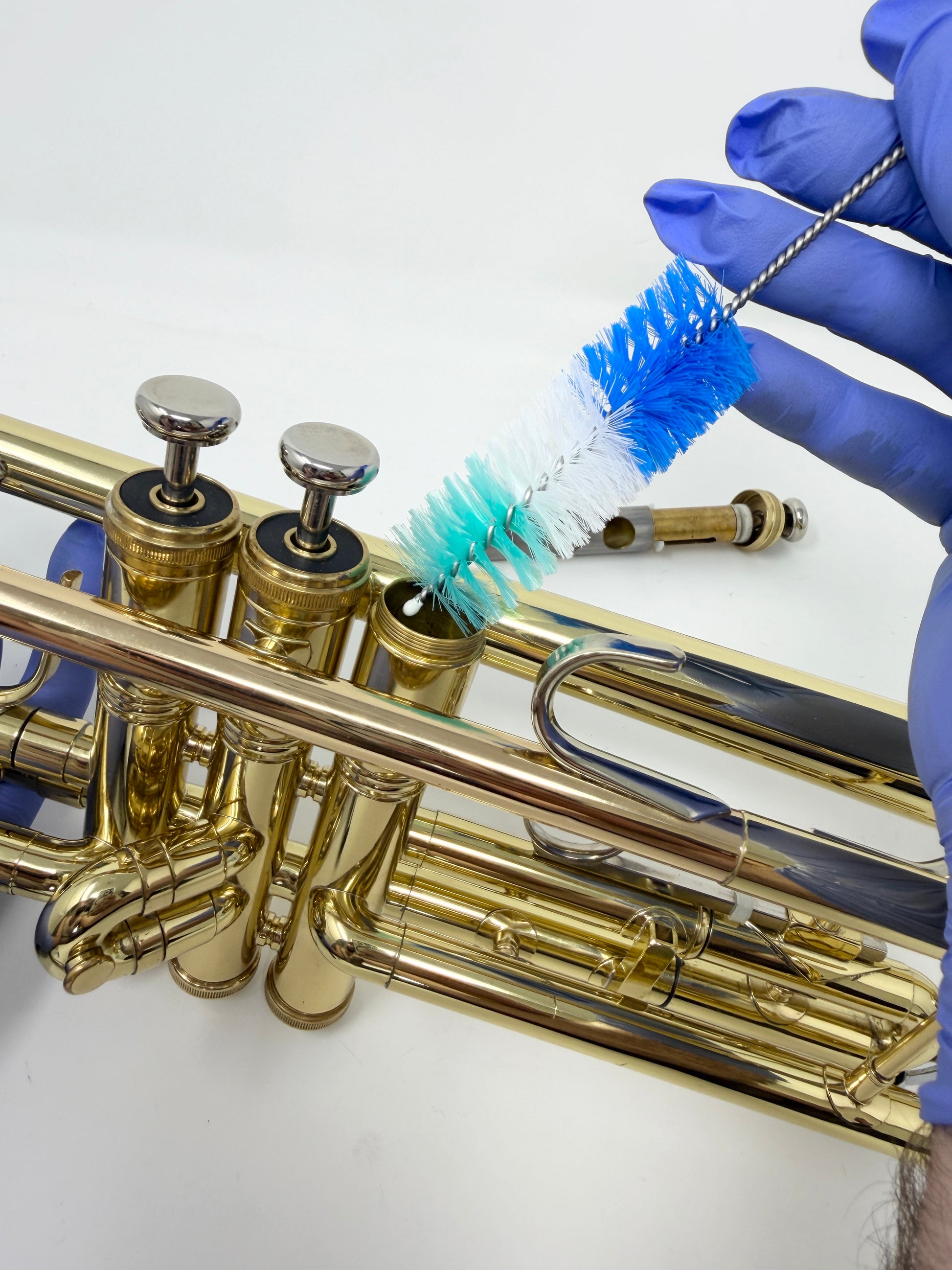 Round brush for cleaning a trumpet