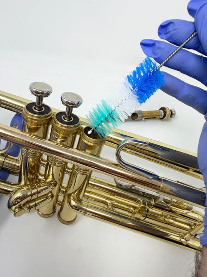 Round brush for cleaning a trumpet